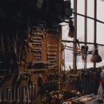 a man sitting in a chair in a room filled with tools